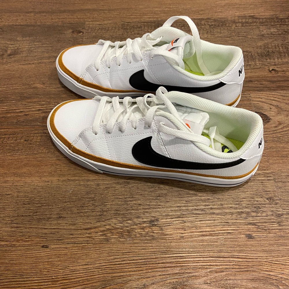 Nike White and Black Athletic Shoes with Gold Accents